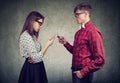 Couple using smartphones totally absorbed in online life, not talking to each other, facing one another.