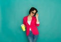 Young girl in bright casual clothing at studio background