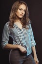 Stylish young lady posing in striped shirt at studio Royalty Free Stock Photo