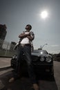 Stylish young male posing by a car Royalty Free Stock Photo