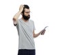 Stylish young man with a beard and glasses with a tablet in his hand. Training, online communication, social networks and blogging Royalty Free Stock Photo