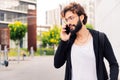 stylish young man talking on mobile phone at city Royalty Free Stock Photo