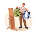 Stylish young man choosing outfit, holding shirts. Fashion stylist deciding what to wear, making choice of apparel