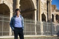 Stylish young man in front of Arco di Costantino, Rome, Italy