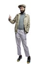 Stylish young man in glasses and with a beard holds a thumbs up. Isolated on a white background. Vertical