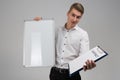 Portrait of young man with clean magnetic Board and contract in his hands isolated on white background