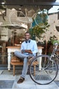 Stylish young man surfing the net at a sidewalk cafe Royalty Free Stock Photo