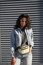 Young mixed race girl wearing sunglasses standing on street looking at camera. Royalty Free Stock Photo