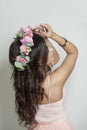 Stylish young model with long curly hair, makeup and perfect healthy skin, floral blossom portrait. Spring beauty, cosmetology,