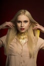 Stylish young model with perfect makeup in red color and gold foil on her neck Royalty Free Stock Photo