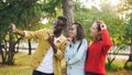 Stylish young people man and women are taking selfie wearing sunglasses posing and smiling holding smartphone during Royalty Free Stock Photo