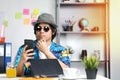 Stylish Young Professional Checking Smartphone While Working on