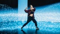 Stylish Young Professional Female Dancer Performing a Hip Hop Dance Routine in Front of Big Led Wa Royalty Free Stock Photo