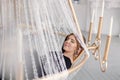 Stylish young rich woman in an evening dress. lobby of the hotel. Suite. Giant huge chandelier lamp. Royalty Free Stock Photo