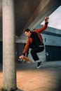 stylish young skateboarder performing jump trick