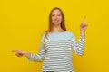 Stylish young smiling woman with fair-haired pointing sideways, left and right, choosing, making decision what to buy, standing