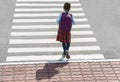 Stylish young teen girl walking with backpack. Active child. Kid runs across the crosswalk. Way forward. Direction to success. Royalty Free Stock Photo