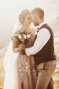 Stylish young wedding couple has fun posing in beautiful Georgian mountains