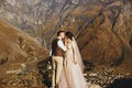 Stylish young wedding couple has fun posing in beautiful Georgian mountains