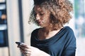 Stylish young woman checking her mobile phone for messages Royalty Free Stock Photo