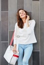Stylish young woman posing against a wall with bag Royalty Free Stock Photo
