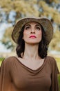 Stylish young woman with straw hat looking up Royalty Free Stock Photo