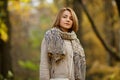 Stylish young woman wearing warm clothes posing in autumn forest Royalty Free Stock Photo