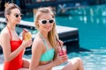 stylish young women with delicious fruit beverages sitting Royalty Free Stock Photo