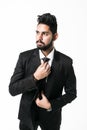 Stylish young indian businessman in suit and tie. Business style. Handsome man is fixing his tie isolated on white Royalty Free Stock Photo