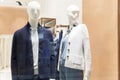 Stylishly dressed male and female mannequins in a clothing store window. New autumn-winter collection Royalty Free Stock Photo
