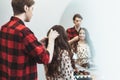 Stylist barber styling long hair for beautiful asian young woman in the beauty salon, working moment Royalty Free Stock Photo