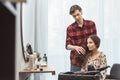 Stylist barber styling long hair for beautiful asian young woman in the beauty salon, working moment Royalty Free Stock Photo