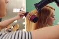Stylist blow drying woman`s hair Royalty Free Stock Photo