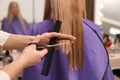 Stylist cutting hair of client in professional salon, closeup Royalty Free Stock Photo
