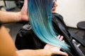 Stylist demonstrates his work with Beautiful girl. Barber haircut dyed hair color blue Royalty Free Stock Photo