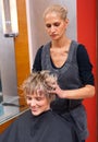 Stylist drying woman hair Royalty Free Stock Photo