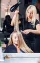 Stylist drying woman hair Royalty Free Stock Photo