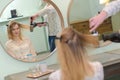 Stylist drying woman hair in beauty salon Royalty Free Stock Photo