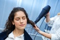 Stylist drying woman hair in salon Royalty Free Stock Photo