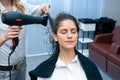 Stylist drying woman hair in salon Royalty Free Stock Photo