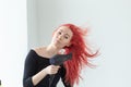 Stylist, fashion, hairdresser, people concept - woman drying her colored hair Royalty Free Stock Photo