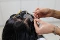 Hair extensions installation with micro ring and keratin bonds in professional salon Royalty Free Stock Photo