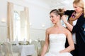 Stylist pinning up a bride's hairstyle