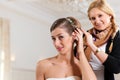 Stylist pinning up a bride's hairstyle Royalty Free Stock Photo