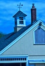 Stylized blues and yellow barn image with cupola and weathervane