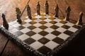 Stylized chess pieces on a board with black background, selective focus