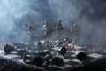 Stylized chess pieces on a board with black background, smoke and selective focus