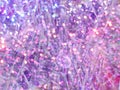 Stylized Christmas background with silver tinsel and violet bokeh