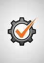 A stylized design features an orange check mark within a grey gear Royalty Free Stock Photo