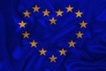 Stylized European Union flag, symbol of united Europe on soft silk with soft folds, close-up